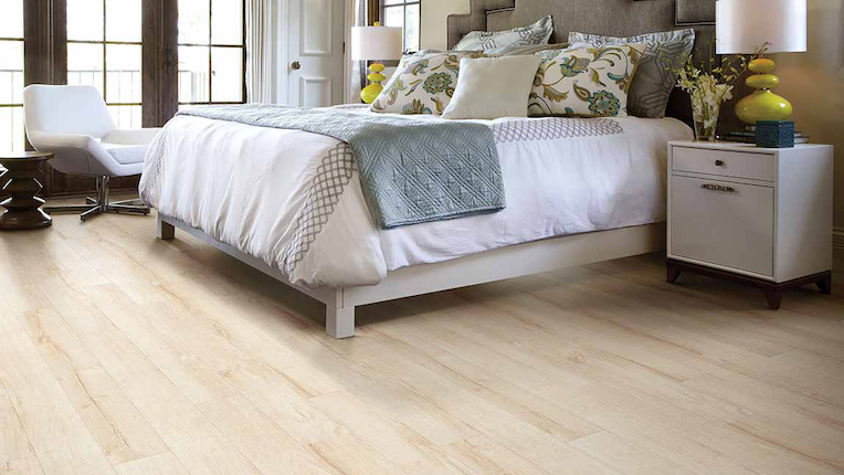 bright wood look laminate flooring in a bedroom